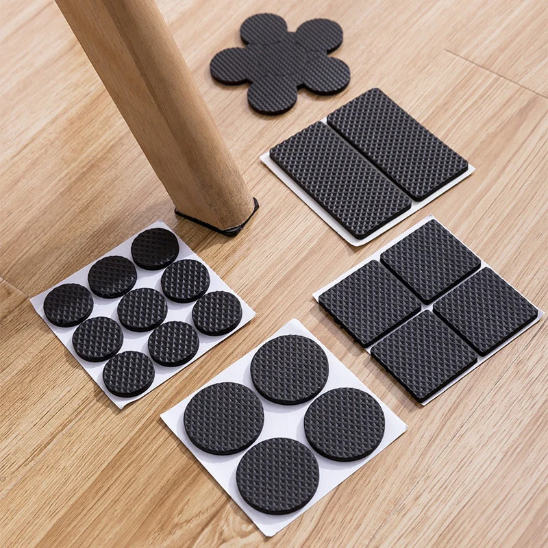 Protective pads on furniture legs to prevent scratches on hardwood floors.